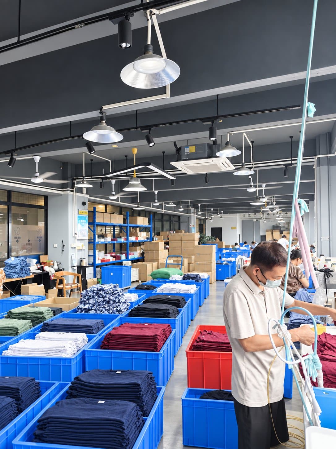 Finished garments sorted into crates on the Abstract Man production floor